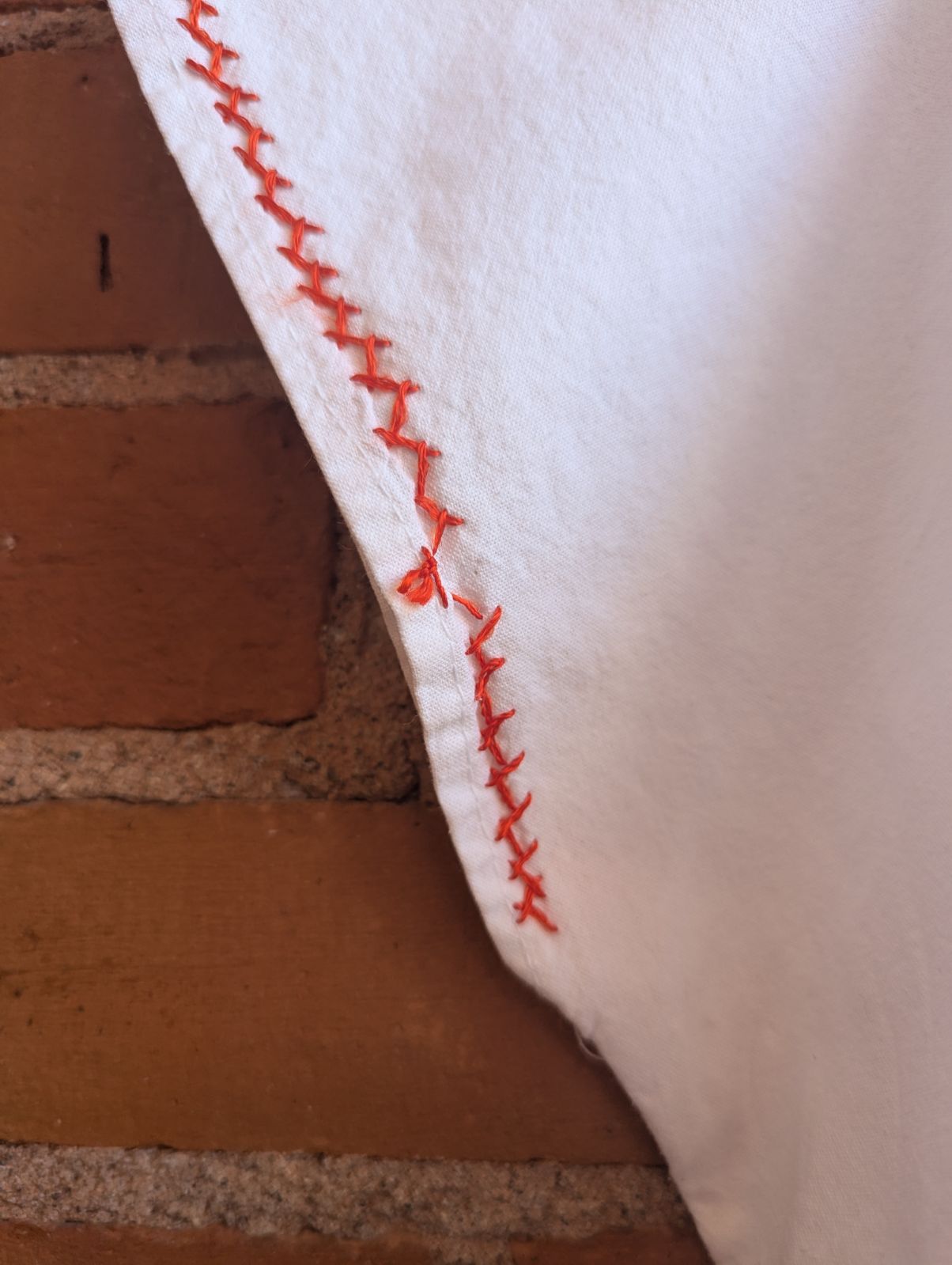 White Cotton V-Neck Blouse With Hand-Embroidered Orange and Yellow Flowers
